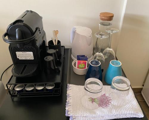 a counter top with a coffee maker and a towel at Casa do Horizonte in Bombarral