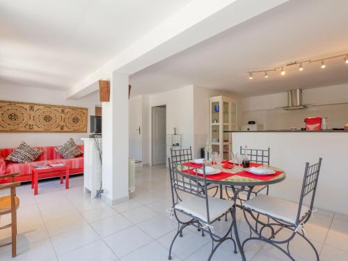 a kitchen and living room with a table and chairs at Apartment Les Collines de valescure by Interhome in Saint-Raphaël