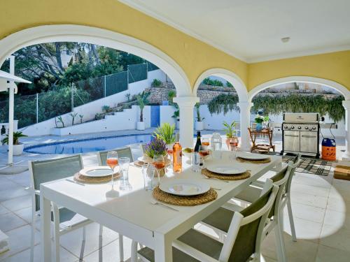 a dining room with a white table and chairs at Villa Villa Ewa by Interhome in Jávea