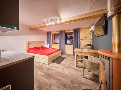 a small bedroom with a bed and a desk at Studio Lesní plovárna by Interhome in Mladé Buky