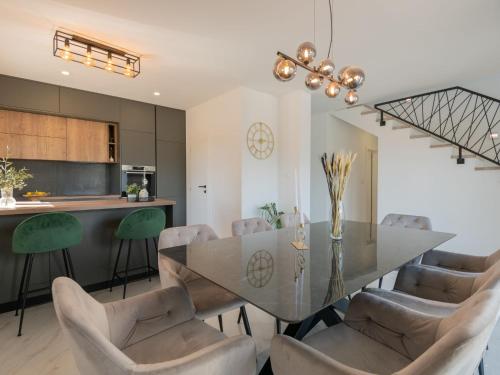 a dining room with a glass table and chairs at Villa Villa Karin by Interhome in Imotski