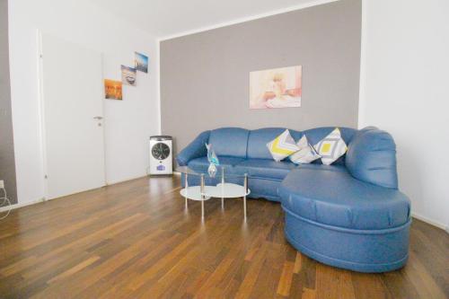 a living room with a blue couch and a table at W Apartment - Brigittenau Area MM15 in Vienna