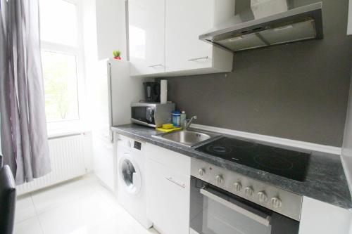 a kitchen with a sink and a stove at W Apartment - Brigittenau Area MM15 in Vienna
