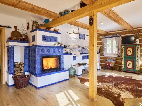 a living room with a blue and white fireplace at Holiday Home Charming Mountain Lodge & Wellness by Interhome in Horní Maršov