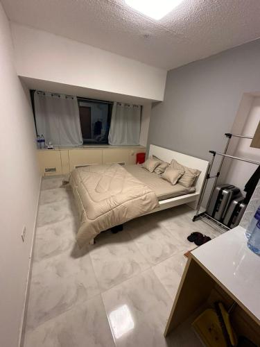 a bedroom with a bed in the middle of a room at Capital dreams homes in Dubai