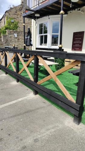 a wooden fence in front of a house at The Bay Horse Hotel Wolsingham in Wolsingham