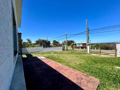 une ombre d'un bâtiment sur le côté d'une cour dans l'établissement Casa Alquiler Cuchilla Alta 2, à Cuchilla Alta