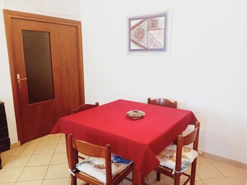 a dining room table with a red table cloth on it at Casa Mercedes in Pau
