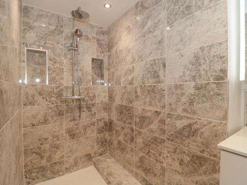 a bathroom with a large shower with a tub at Holly Lodge in Langport