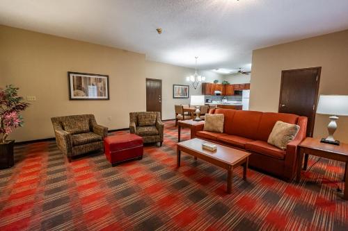 a living room with a couch and chairs at Christopher Inn and Suites in Chillicothe