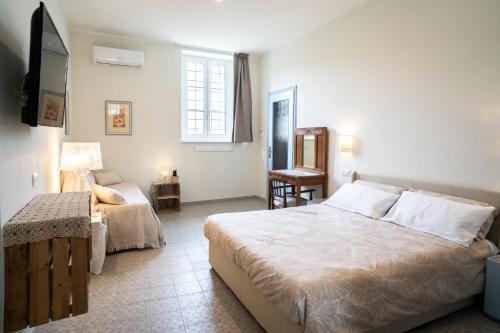 a hotel room with a bed and a television at Riobasco in Albisola Superiore
