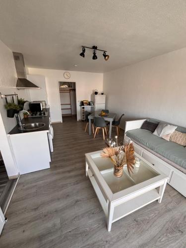 a living room with a couch and a table at Provencal in Cagnes-sur-Mer