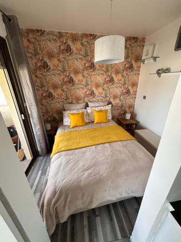 a bedroom with a large bed with yellow pillows at Provencal in Cagnes-sur-Mer
