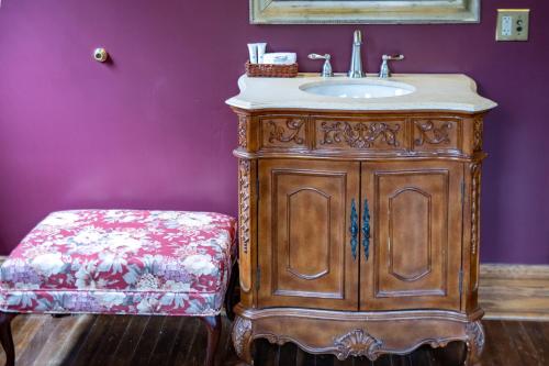 a bathroom with a wooden vanity and a sink at Elk River Hotel & Cafe in Sutton