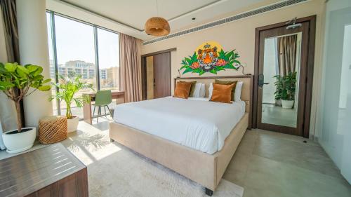 a bedroom with a large bed and a balcony at Nas House Private & Shared Villas in Dubai