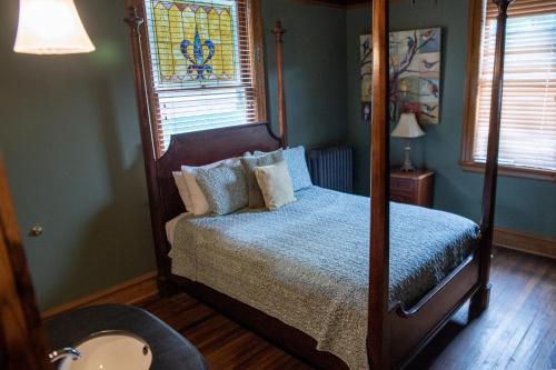 a bedroom with a canopy bed and a window at Elk River Hotel & Cafe in Sutton