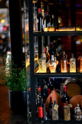 a shelf filled with lots of bottles of wine at Gudauri Loft Hotel in Gudauri