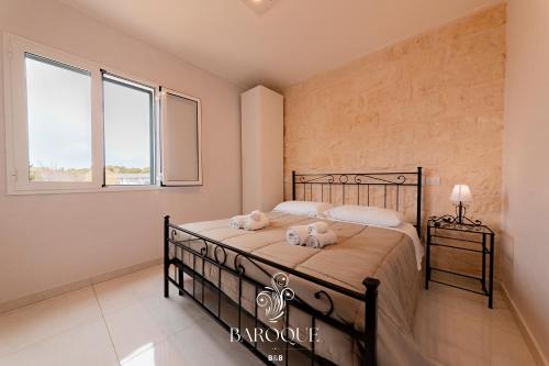 a bedroom with a bed with two towels on it at Baroque B&B in Lecce