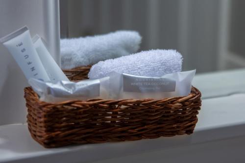 a basket of toiletries sitting on a bathroom counter at Elk River Hotel & Cafe in Sutton