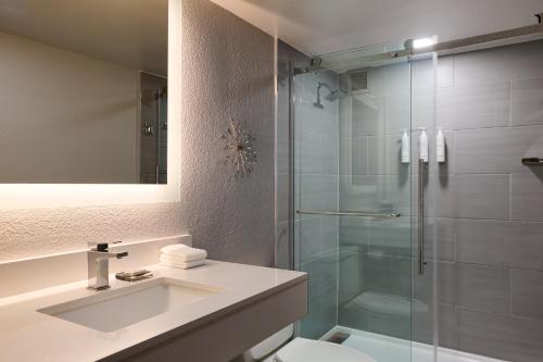 a bathroom with a shower and a sink and a toilet at Marriott El Paso in El Paso