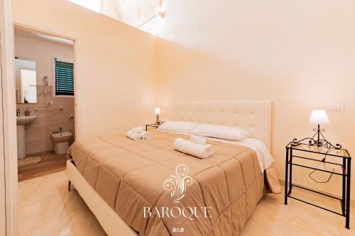 a bedroom with a bed with towels on it at Baroque B&B in Lecce