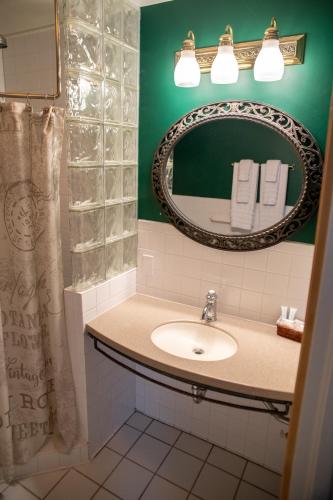 a bathroom with a sink and a mirror at Elk River Hotel & Cafe in Sutton
