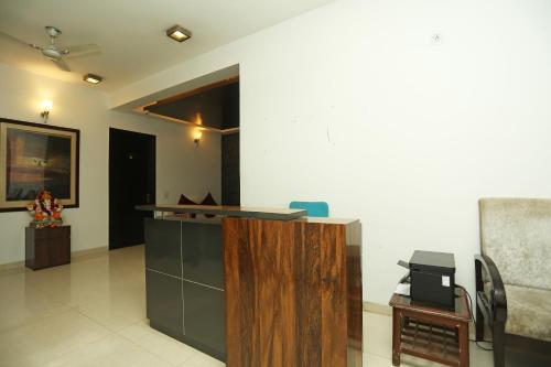 an office with a desk and a chair in a room at OYO 18851 Hotel Sagarmatha in Gurgaon