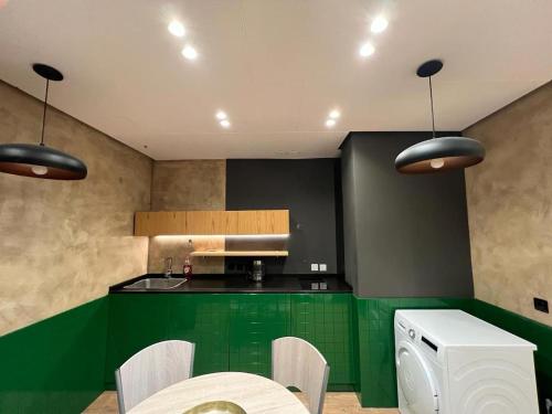 una cocina con encimeras verdes y un aparato blanco en Remarkable Apartment, en Tirana
