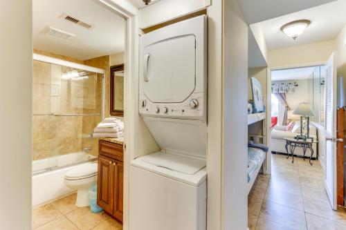 a bathroom with a washer and dryer next to a toilet at Ocean-View Balcony Beachfront Hilton Head Condo in Hilton Head Island