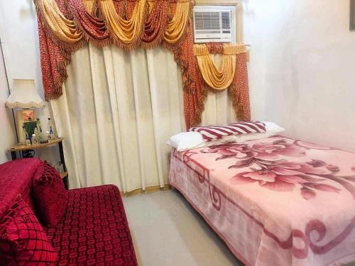 a bedroom with a bed and a window with curtains at Affordable Spacious Bedroom & Bathroom near DVO Airport in Davao City