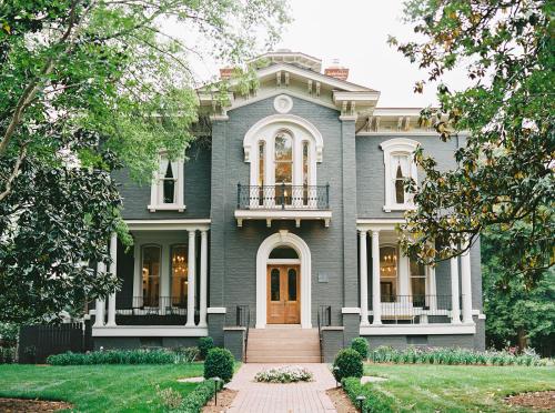 a blue house with a staircase in front of it at Heights House Hotel in Raleigh