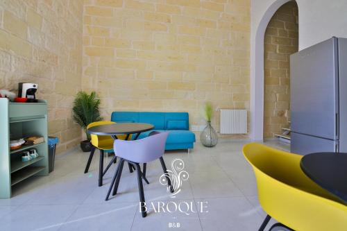 a room with a table and chairs and a brick wall at Baroque B&B in Lecce