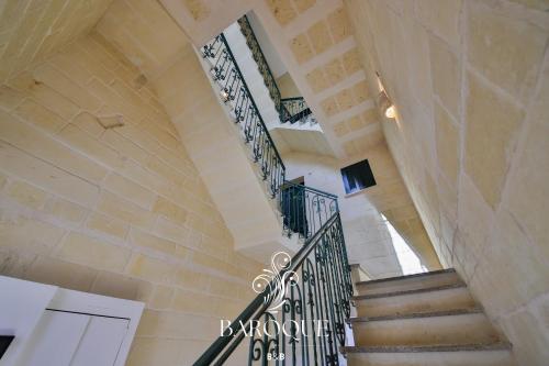 a spiral staircase in a building with a stair railing at Baroque B&B in Lecce