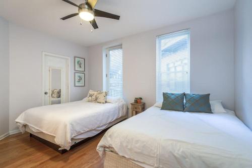 a bedroom with two beds and a ceiling fan at Lincoln Park Living - Suite 2 in Chicago