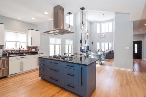 a kitchen with a stove top island in a room at Eclectic Stylish and Cozy Milwaukee Unit in Milwaukee