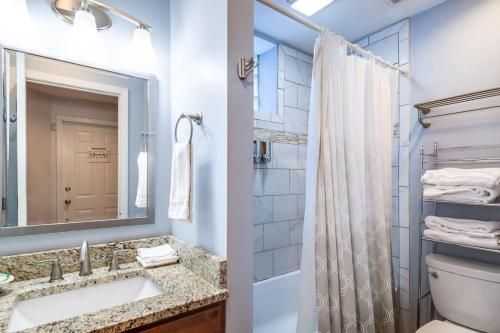 a bathroom with a sink and a toilet and a mirror at Lincoln Park Living - Suite 2 in Chicago