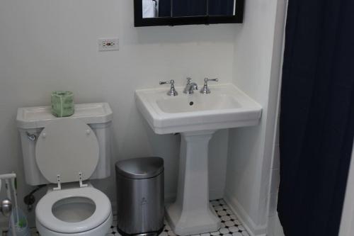 a white bathroom with a sink and a toilet at Lincoln Park Living - 3 Queen Beds - Sleeps 6 in Chicago