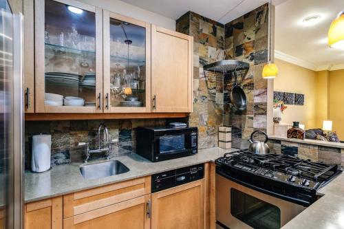 a kitchen with a sink and a stove at Brownstone in Gold Coast - Downtown in Chicago