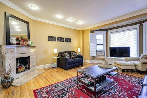 a living room with a couch and a fireplace at Brownstone in Gold Coast - Downtown in Chicago