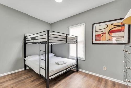 a bedroom with two bunk beds and a window at 717a - Settle into Soulard 6 Q beds 2 full baths in Soulard