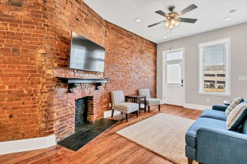 a brick wall in a living room with a fireplace at St Louis Townhome-Perfect for Groups in Tower Grove
