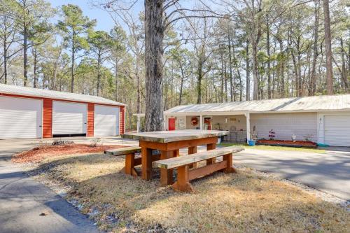 a picnic table in front of a building at Secluded Newport Getaway with Fire Pit and Grill! in Havelock