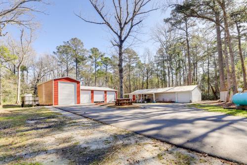 a driveway with two garages in the woods at Secluded Newport Getaway with Fire Pit and Grill! in Havelock