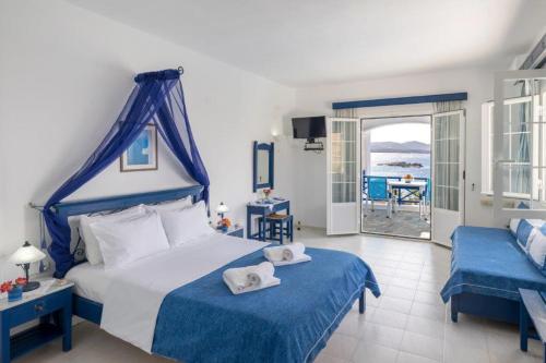 a bedroom with a bed and a view of the ocean at Sea View Studios in Finikas