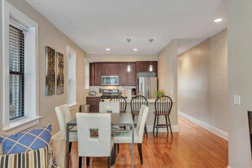 a dining room and kitchen with a table and chairs at Stunning Townhome 920 in The Grove in Tower Grove