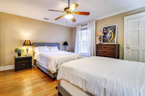 a bedroom with two beds and a ceiling fan at Brownstone 2 entire units Gold Coast in Chicago