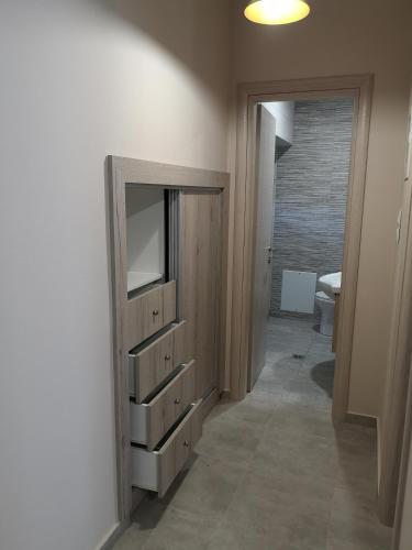 a bathroom with a dresser with a television in it at Aegean View Mikro Pelion in Mikro