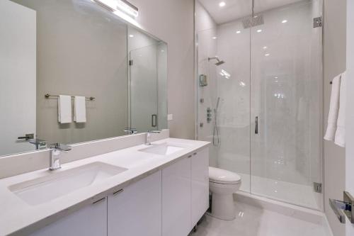 a white bathroom with a toilet and a shower at Stunning Condo #2 - Downtown River North in Chicago