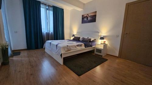 a bedroom with a bed and a large window at Doxa Airport Otopeni in Otopeni