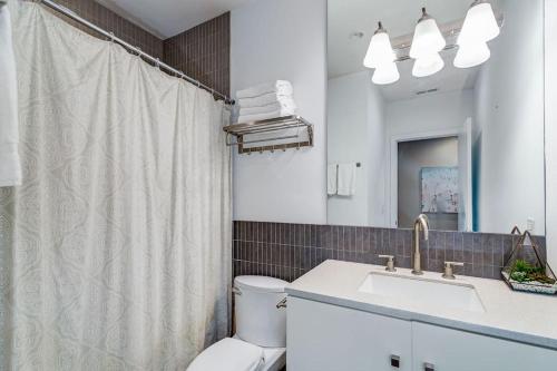 a bathroom with a toilet and a sink and a shower at 870 bldg - 3 Separate Suites in same building in Chicago